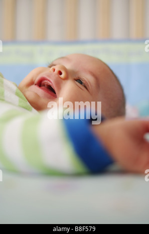 Smilling baby in crib Stock Photo