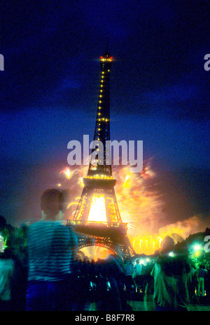 Fireworks light the sky behind the Eiffel Tower, Paris, on Bastille Day Stock Photo