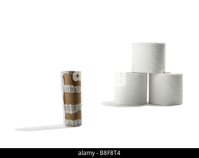 Rolls of Toilet Paper with Empty Roll in Foreground Stock Photo