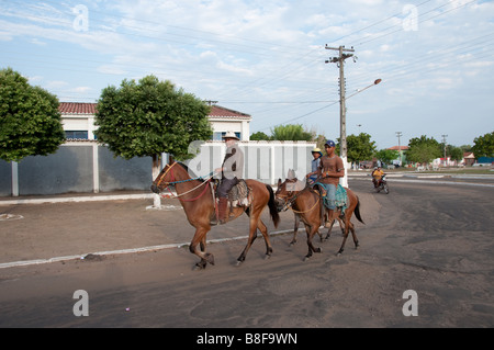Three farmers come into town on their horses 29 10 2008 Carolina Maranhao Brazil Stock Photo