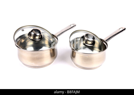 Two Stainless Steel Saucepans with glass lids against a white background Stock Photo