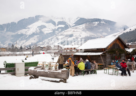 Rauris Austria Europe January People sitting outside ski resort cafe in Austrian Alps in winter snow Stock Photo