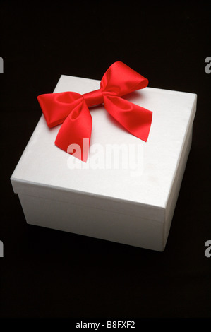 The red square box is tied with a black ribbon. Gift, top view ...