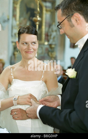 Bridegroom putting the Ring on his Bride's Finger - Ritual - Wedding - Christianity - Tradition - Church Stock Photo