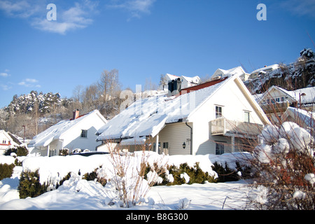 Snow covered rooftop of a traditional Norwegian House and garden Stock Photo
