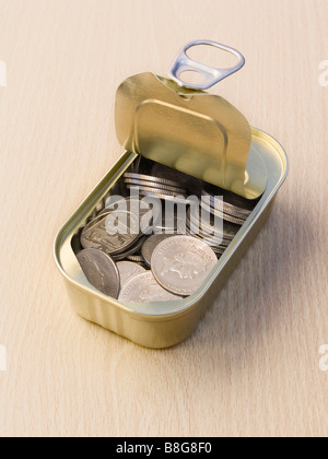 Ring Pull Tin Can Containing Ten Pence Pieces on a Wooden Surface Stock Photo