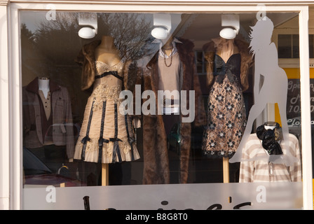 A shop window displaying womens fur coats and other expensive clothes in the uk Stock Photo