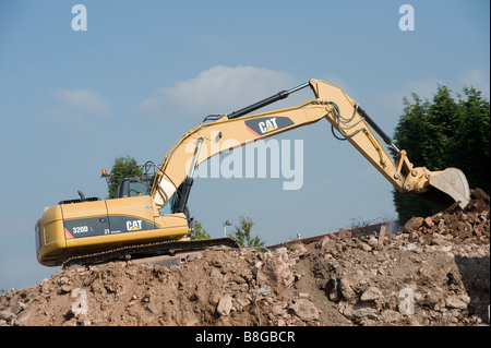 Yellow Caterpillar 320D tracked hydraulic excavator working on a building site in england Stock Photo