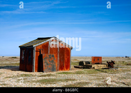 Old rusty metal shed on Dungeness beach Stock Photo