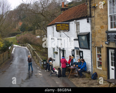 A group of walkers outside a small village pub in winter Stock Photo