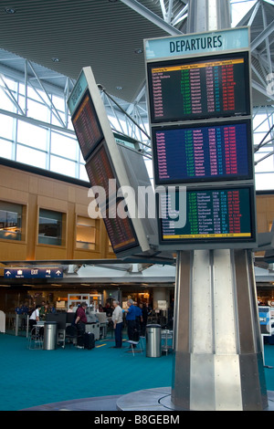 Airline departure notice board at the Portland International Airport in Portland Oregon USA Stock Photo