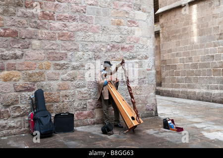 Busker playing the harp in the Gothic Quarter, Barcelona, Spain Stock Photo