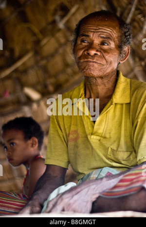 Village elder sits in meeting hut in traditional Timorese village of None near Soe, Indonesia Stock Photo