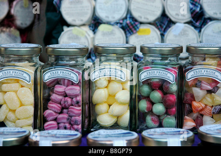 Glass jars of traditional sweets in a shop window. Stock Photo