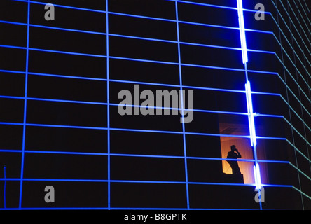 Executives at work in office setting with computer. Late night. Stock Photo