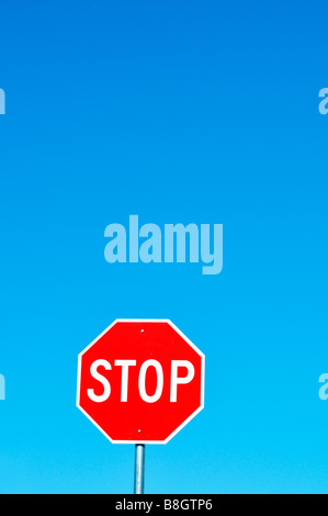 Stop sign red and white against clear deep blue sky Stock Photo