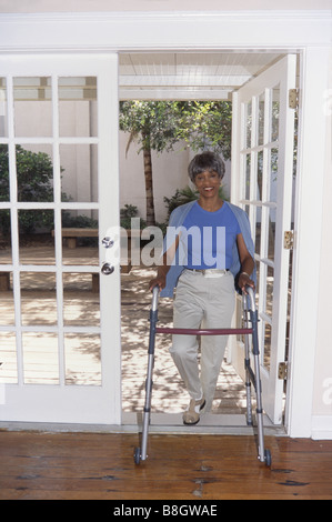 Seniors exercising, walking with walker,handicapped Stock Photo