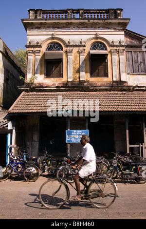 India Pondicherry motorcycles parked outside derelict old French colonial building Stock Photo