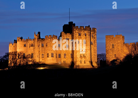 A floodlit Alnwick Castle, home to the Duke and Duchess of Northumberland Stock Photo