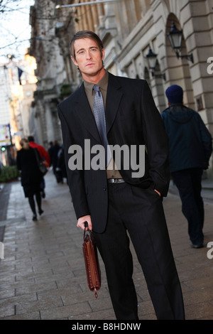 Business professional man carrying a briefcase in financial district Stock Photo