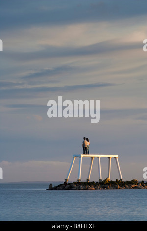 'The Couple' a sculpture installed off the coast of Newbiggin by the Sea by the artist and sculptor Sean Henry Stock Photo