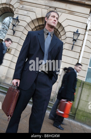 Business man carrying briefcase in the financial district Stock Photo
