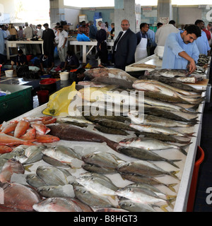 Fish displays and fishmonger vendors at work in Fujairah fish market Emirate of Fujairah on the east coast of UAE Stock Photo