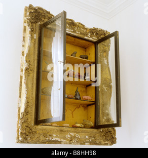 Recessed wall cabinet with an old picture frame around it Stock Photo
