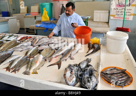 Fish display and fishmonger vendors at work in Fujairah fish market Emirate of Fujairah on the east coast of UAE Stock Photo