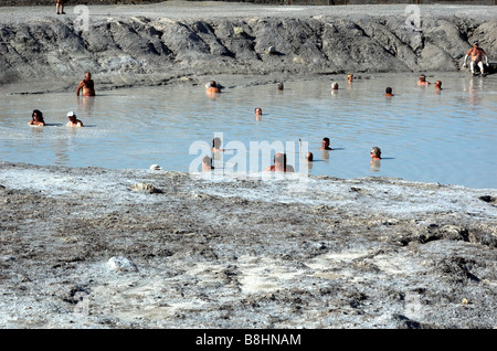 view of tourist enjoying mud bath on island of Vulcano in the aeolian Islands off Sicily Stock Photo