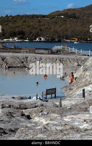 view of tourist enjoying mud bath on island of Vulcano in the aeolian Islands off Sicily Stock Photo