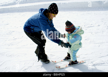 Small child learning to snow ski Stock Photo