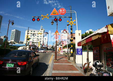 steet scene in   Busan  (Pusan)  in  South Korea, a goods transportation train is passing by Stock Photo