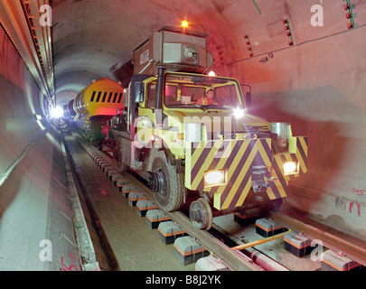 Unimog road-rail machine pulling a works cleaning train on newly laid railtracks in a section of Channel Tunnel rail tunnel. Stock Photo
