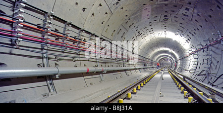 Engineer inspecting newly laid trackwork in a Jubilee Line Extension tunnel on the London Underground Tube network. Stock Photo