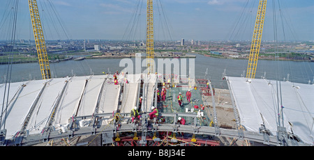Attaching the PFTE-coated fabric roof to the cable net structure during building of the Millennium Dome/O2 Arena in London, UK. Stock Photo