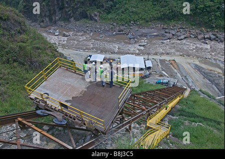 Conveyor system transporting materials and workers between upper and lower sites on a hydropower project in Ecuador. Stock Photo