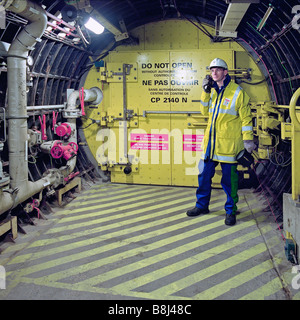 Eurotunnel engineer checking systems in an emergency cross passage between a Channel Tunnel rail tunnel and the service tunnel Stock Photo