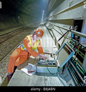 Commissioning engineer carries out final testing on electrical equipment before handover to Eurotunnel on Channel Tunnel project Stock Photo
