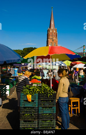 Outdoor marketplace with St Anna s Church in the background in Liepaja Latvia Europe Stock Photo