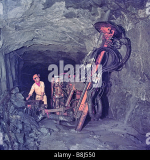 Accurate long hole drilling in Philippine mine allows explosive blasting to remove sections of rock with precision. Stock Photo
