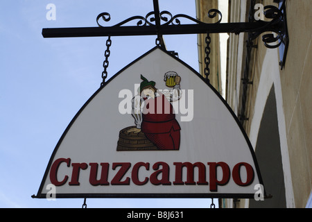 A sign advertising a brand of beer hangs in front of a traditional bar on the island of Mallorca. Stock Photo