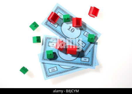 Monopoly houses and hotels on top of toy bank notes Stock Photo