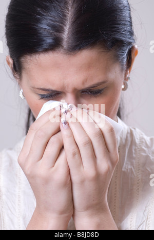 Woman crying and wiping tears with tissue Stock Photo