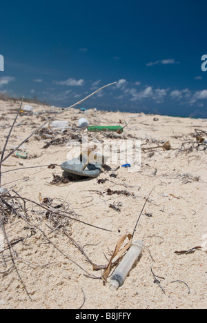 Plastic trash washed ashore on the white sand beach near Tulum Mexico. Stock Photo