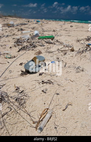 Plastic trash washed ashore on the white sand beach near Tulum Mexico. Stock Photo