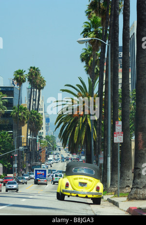A yellow Beetle car on an american boulevard, Los Angeles CA Stock Photo