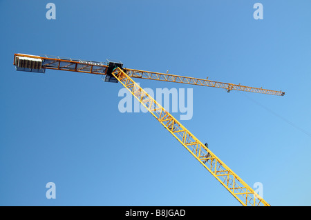 A yellow painted tower crane Stock Photo