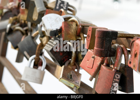 Closeup of many locked padlocks attached to each other according to wedding tradition. Stock Photo
