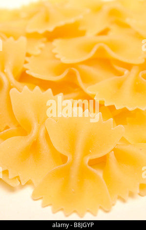 farfalle pasta close up food dried egg flour bow tie wheat shaped durum edible carbohydrates italian store eating boil Stock Photo